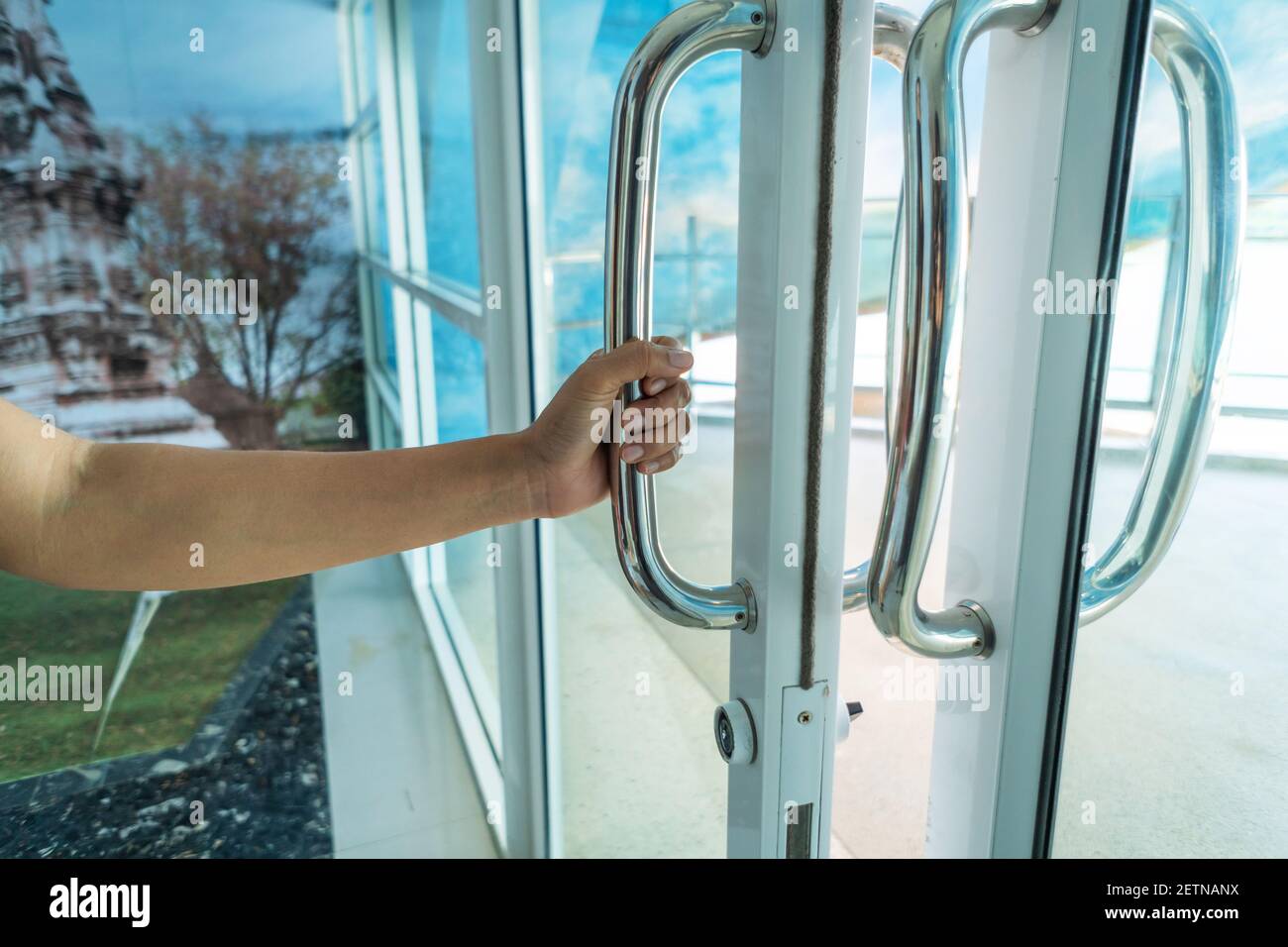 Woman's hand Opening glass door Stock Photo Alamy