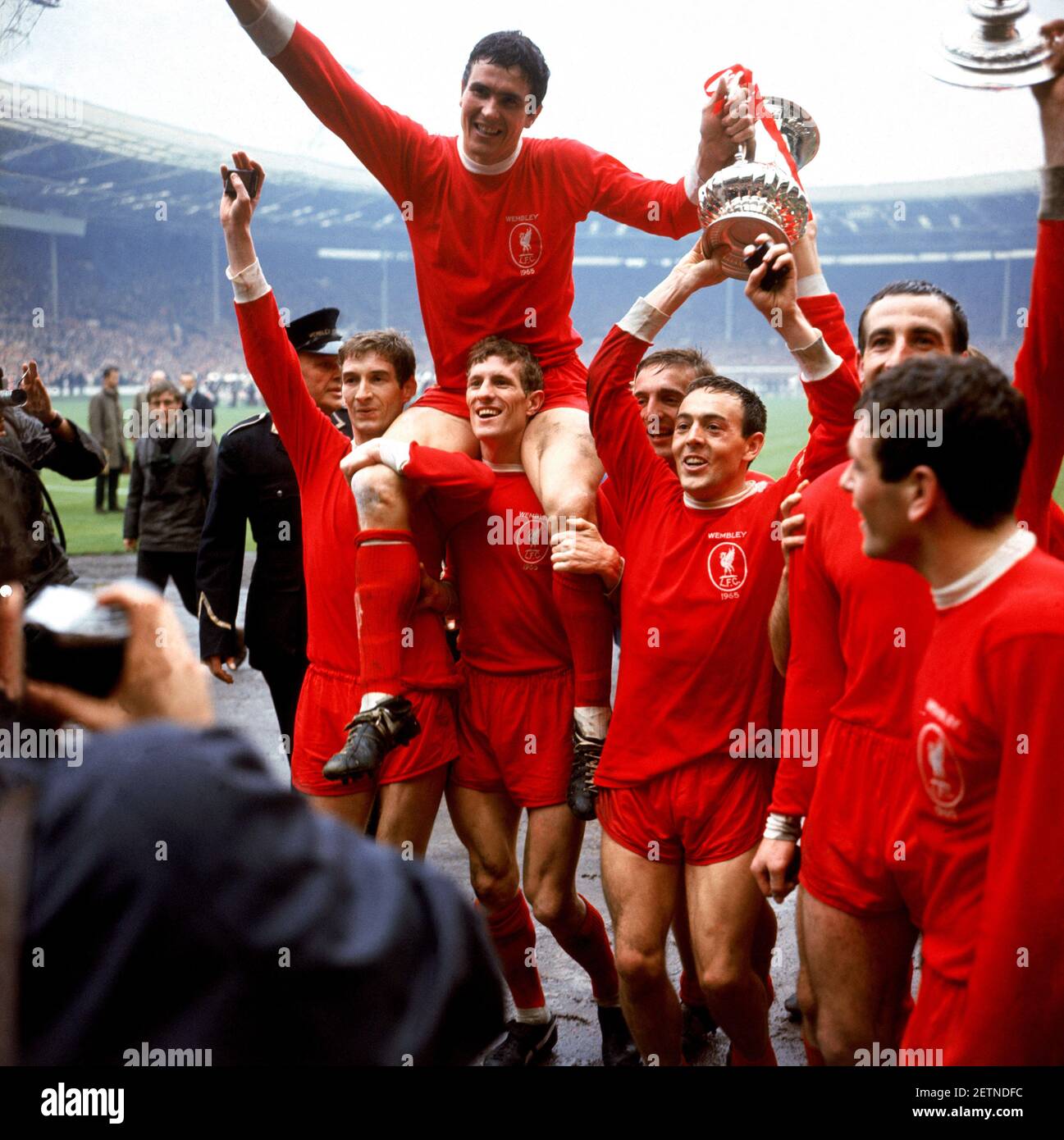 File photo dated 01-05-1965 of Liverpool captain Ron Yeats (top) holds onto the FA Cup as he is hoisted aloft by his jubilant teammates after their 2-1 win: (l-r) Geoff Strong, Yeats, Wilf Stevenson, Peter Thompson, Ian St John, Gerry Byrne, Ian Callaghan Issue date: Tuesday March 2, 2021. Stock Photo