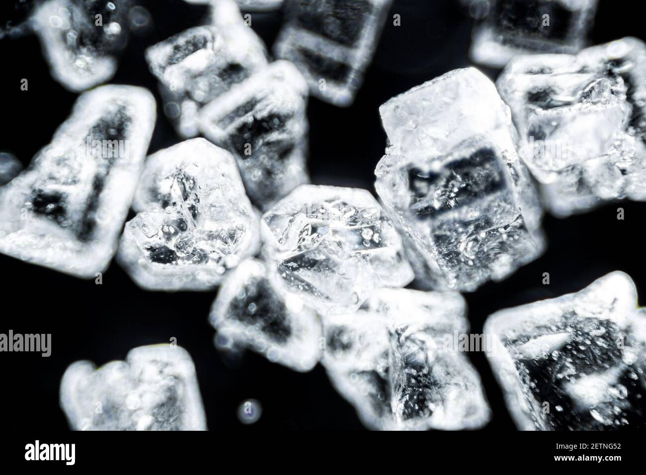 Crystal sugar close up on black background under the light microscope