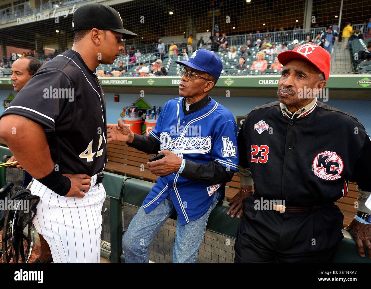 The Charlotte Knights' Tyler Ladendorf, left, listens to former Negro  League player Bill Cathcart, center, as Sam Allen, right, looks on prior to  the Knights' game against the Pawtucket Red Sox at