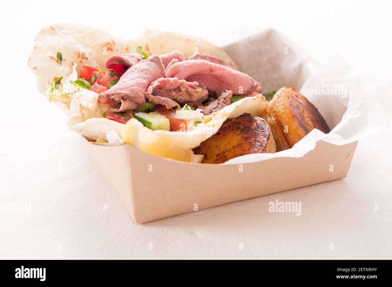 food truck meal of lamb wrap with roasted potato, shawarma style with