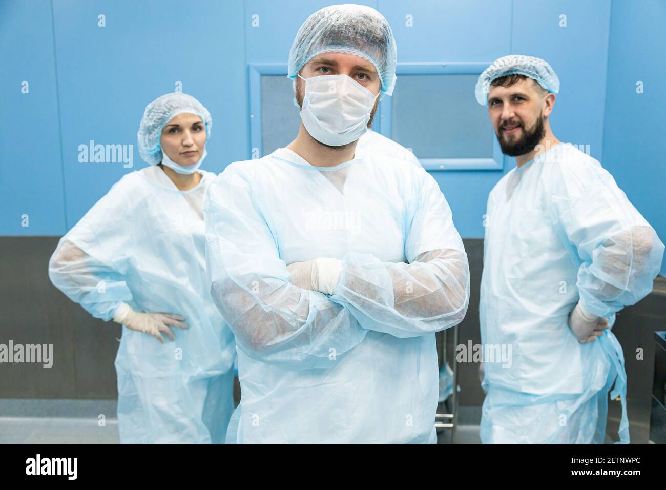 Doctors In Uniform Portrait of a team of doctors in uniform and medical masks after ...
