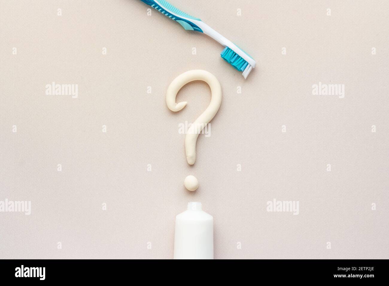 Question mark of toothpaste with toothbrush, top view. Oral care and