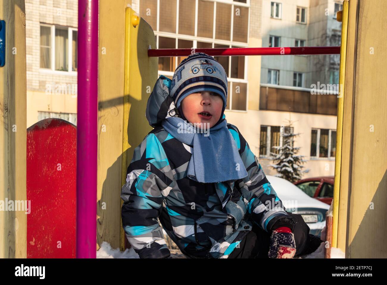 Cute boy in winter clothes on the background of the building. Photo taken in Chelyabinsk, Russia. Stock Photo