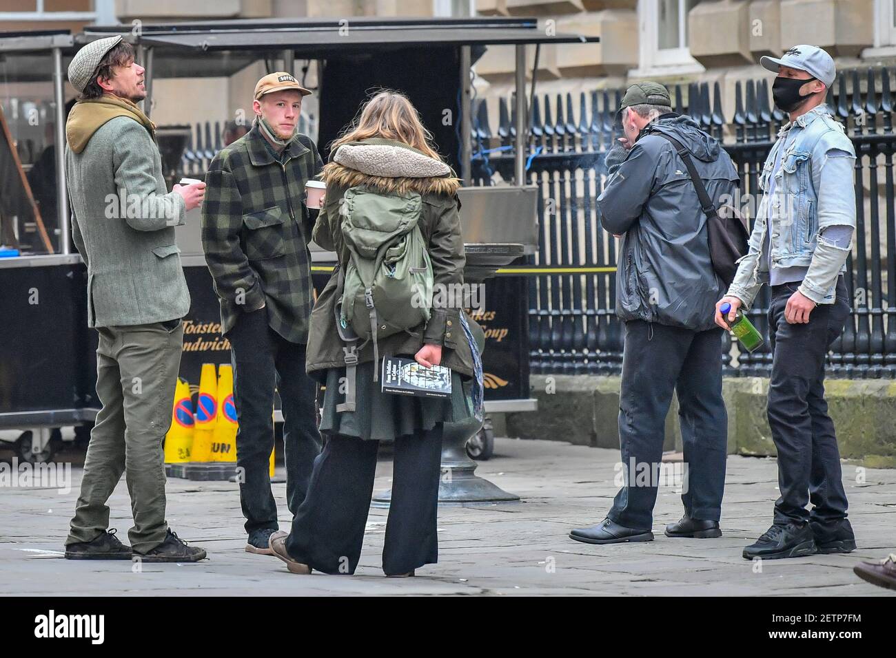 Milo Ponsford (second right, green check jacket), Rhian Graham (centre, back to camera) and Jake Skuse (right, black mask and denim jacket) have a coffee with unknown people, before attending Bristol Crown Court where they and one other are appearing charged with criminal damage over the toppling of the Edward Colston statue in Bristol during the Black Lives Matter protests in June last year. Picture date: Tuesday March 2, 2021. Stock Photo