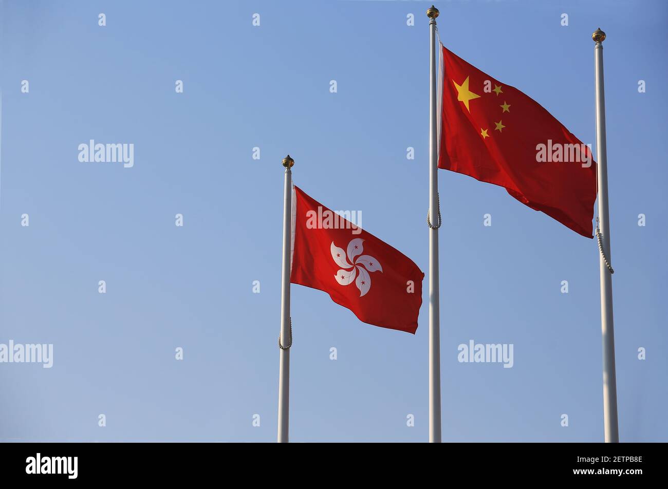 the hong kong flag and chinese flag against the sky Stock Photo