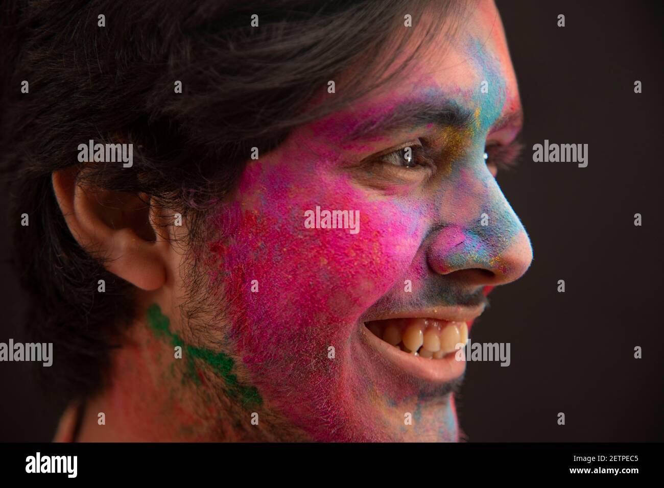 PORTRAIT OF A YOUNG MAN WITH GULAL ON HIS FACE SMILING Stock Photo