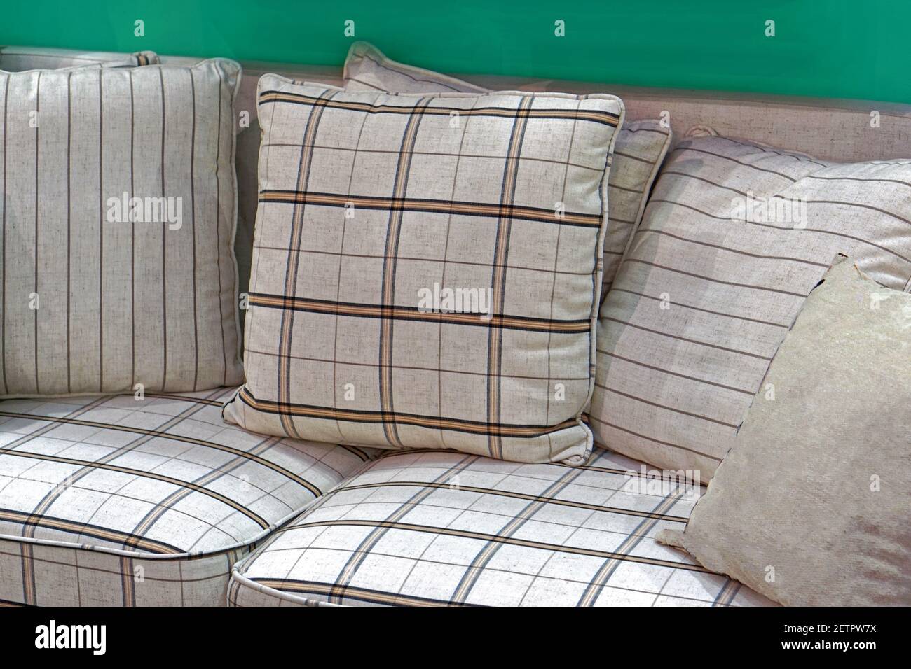Decorative pillows at plaid textile sofa living room Stock Photo