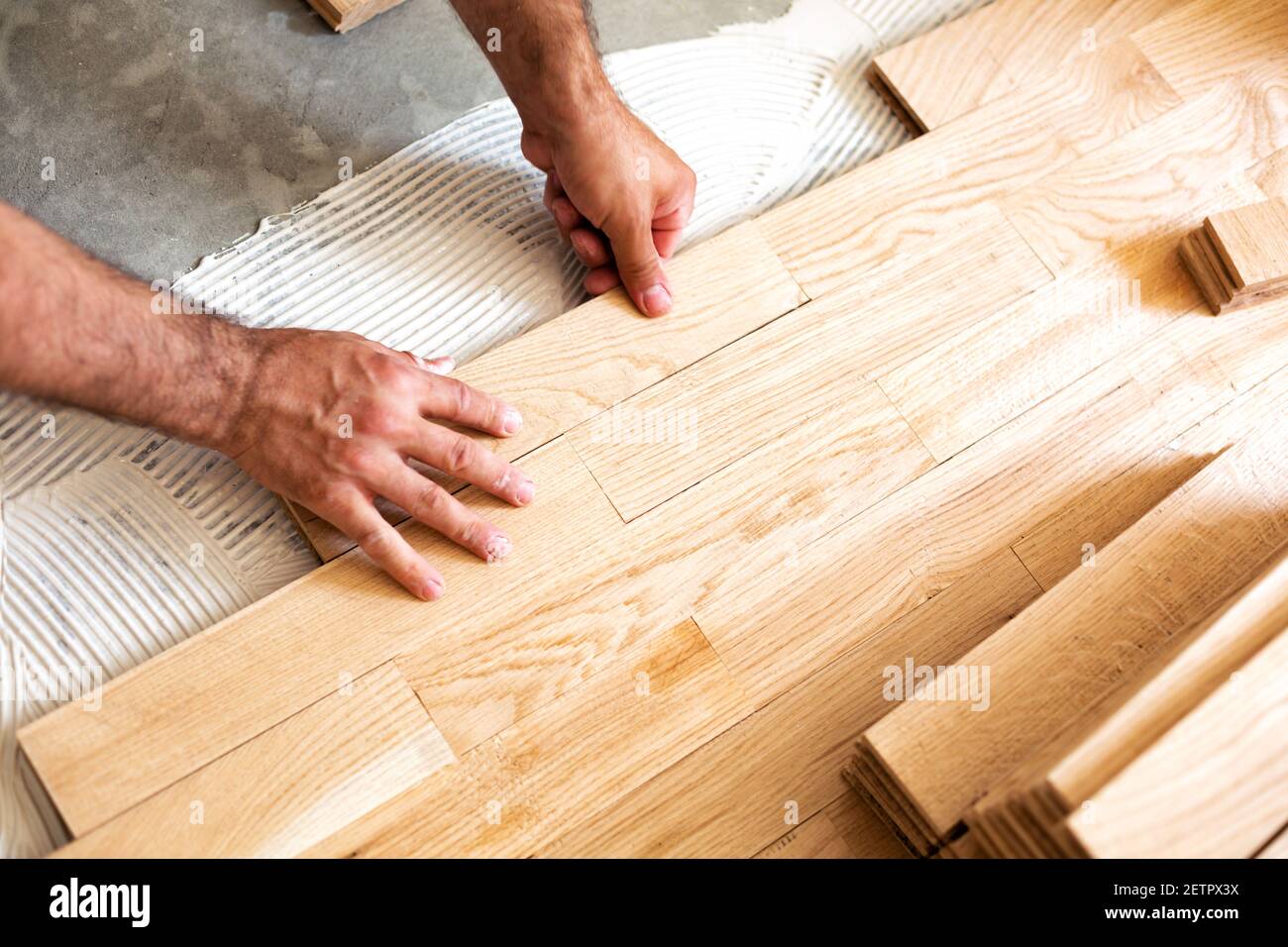 Assembly of patterned wood surface on a stable mixture subfloor glue