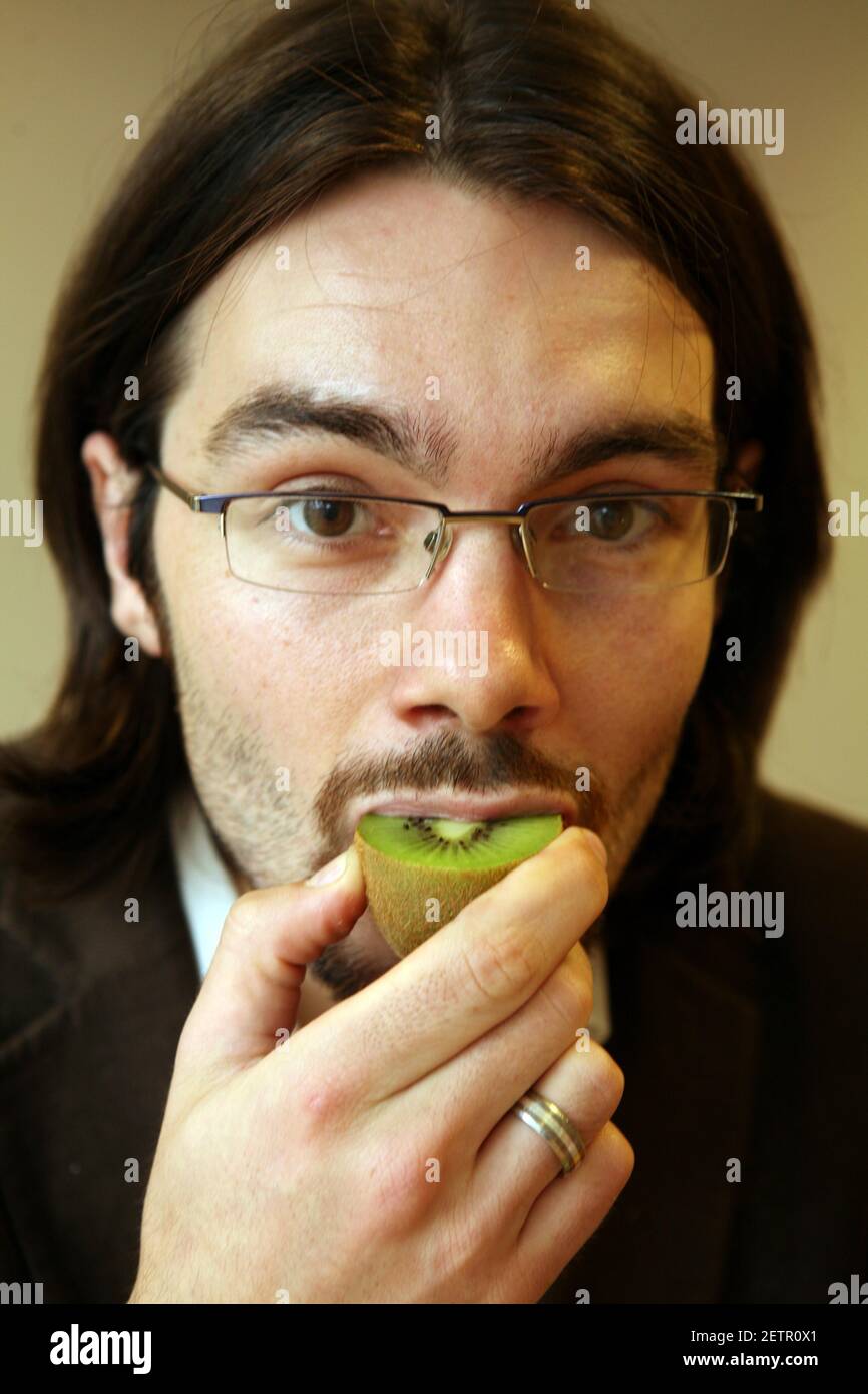 Jerome Taylor tries MIRACLE FRUIT ( Synsepalum Dulcificum) which makes sour and bitter foods taste sweeter.photograph by David Sandison The Independent Stock Photo