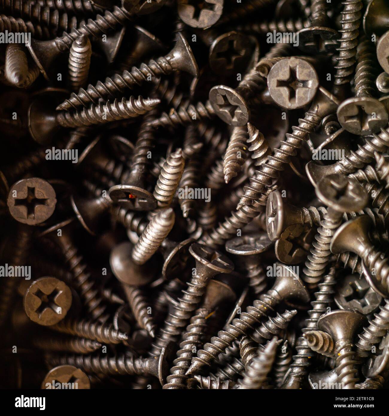 heap of new black selftapping screws closeup Stock Photo Alamy