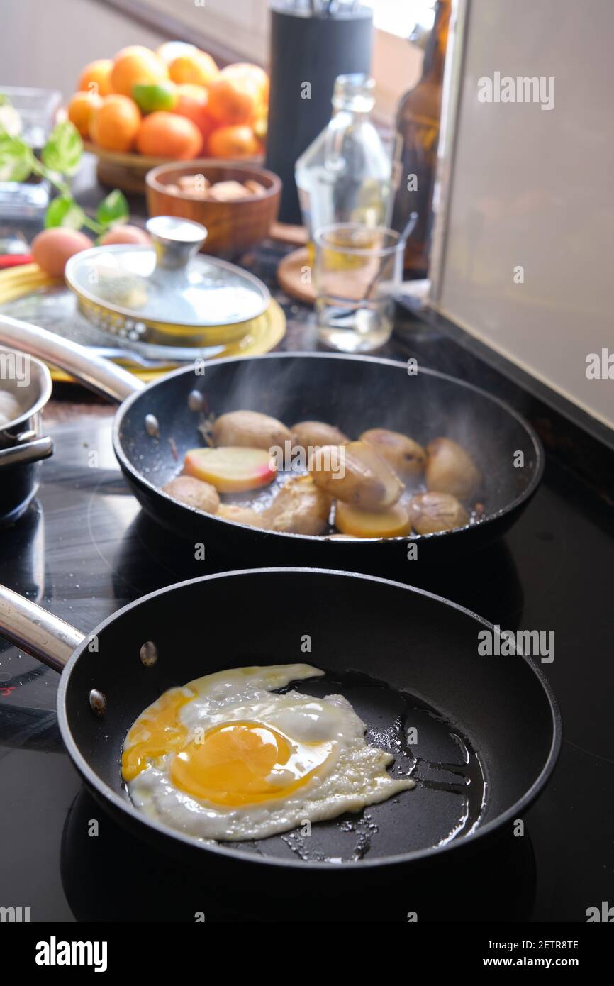 preparing fried eggs in a frying pan Stock Photo