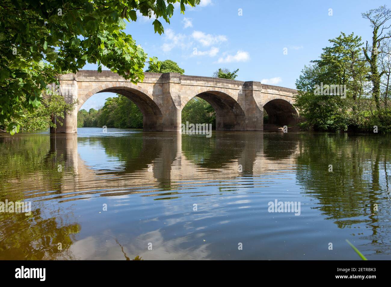 Summer view of the old stone bridge over the River Ure at Masham in North Yorkshire Stock Photo