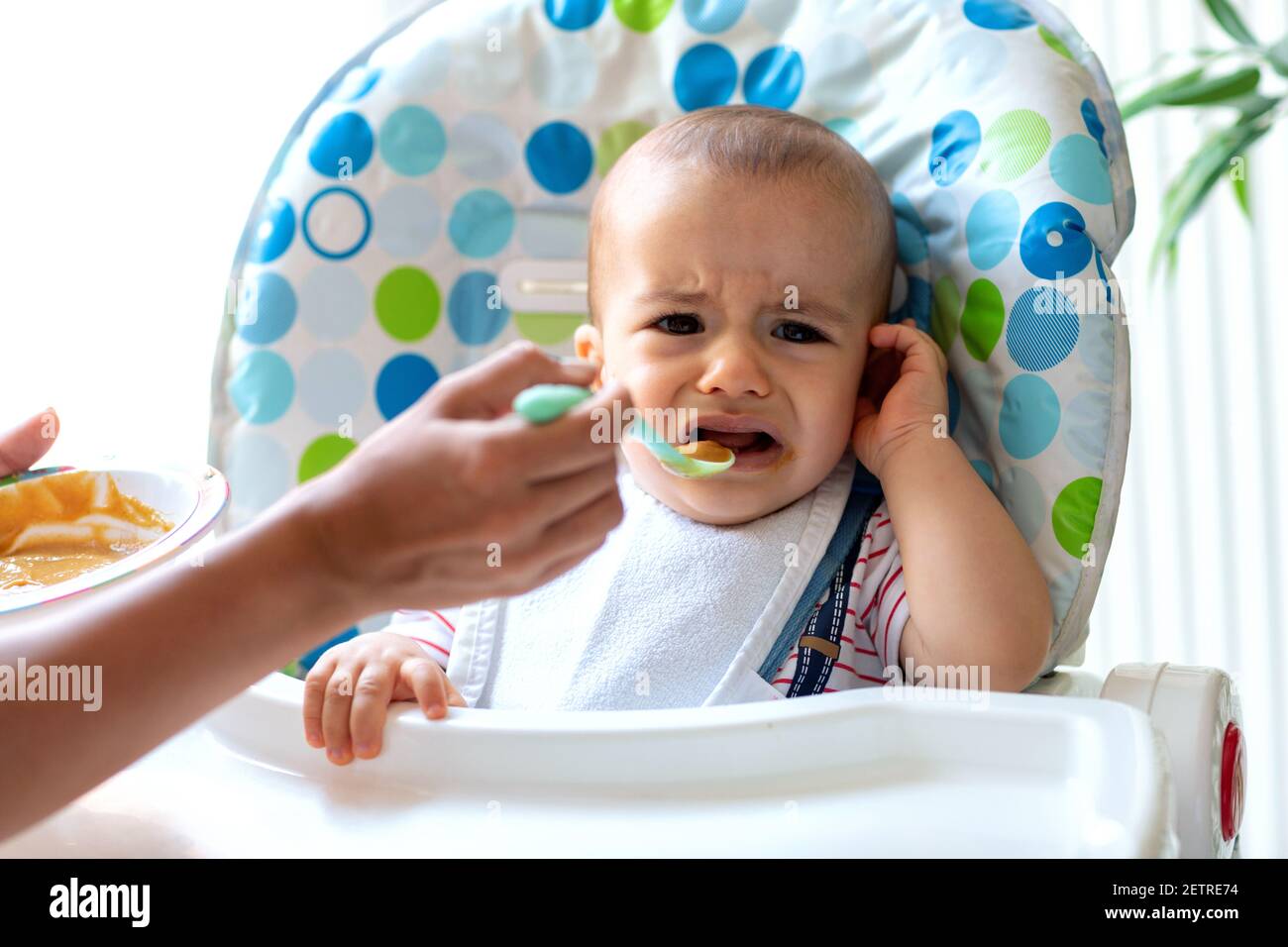 Crying baby refusing to eat anymore porridge and convincing his parent