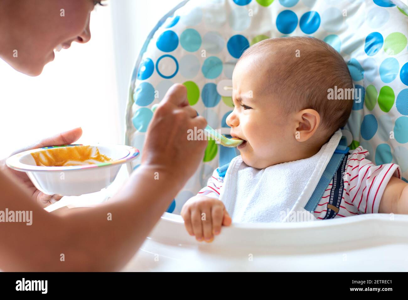 baby crying while eating cereal