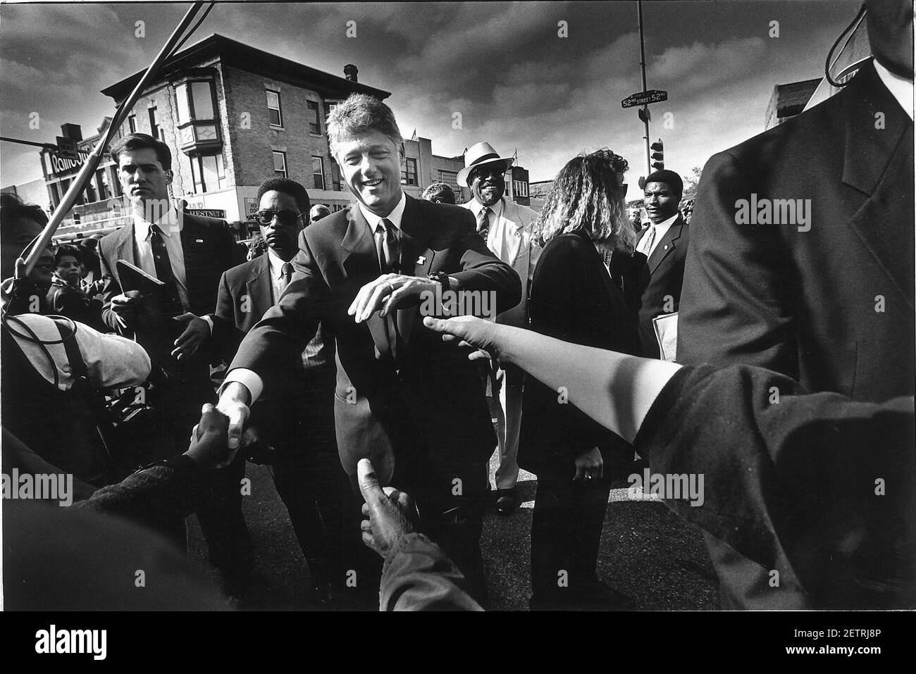 Bill Clinton shaking hands with the cowds in the black area of Philladelphia Stock Photo
