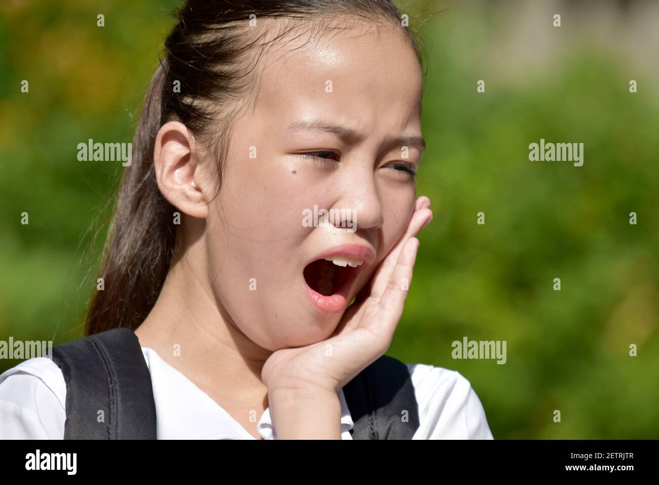 Pretty Diverse School Girl Student Teenager Yawning Stock Photo
