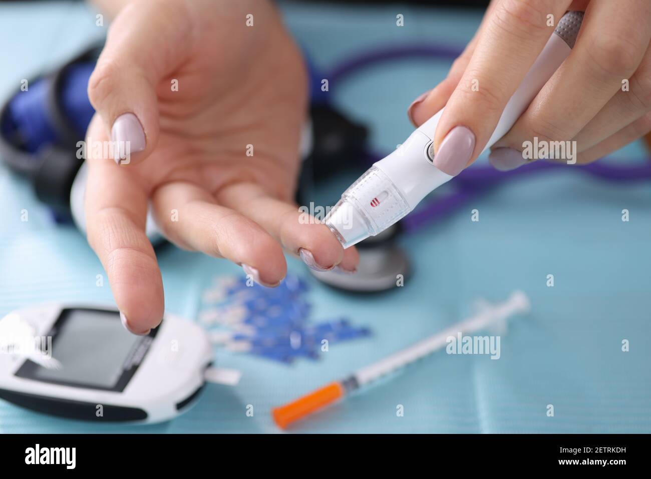 Woman drawing blood with lancet at home closeup Stock Photo Alamy