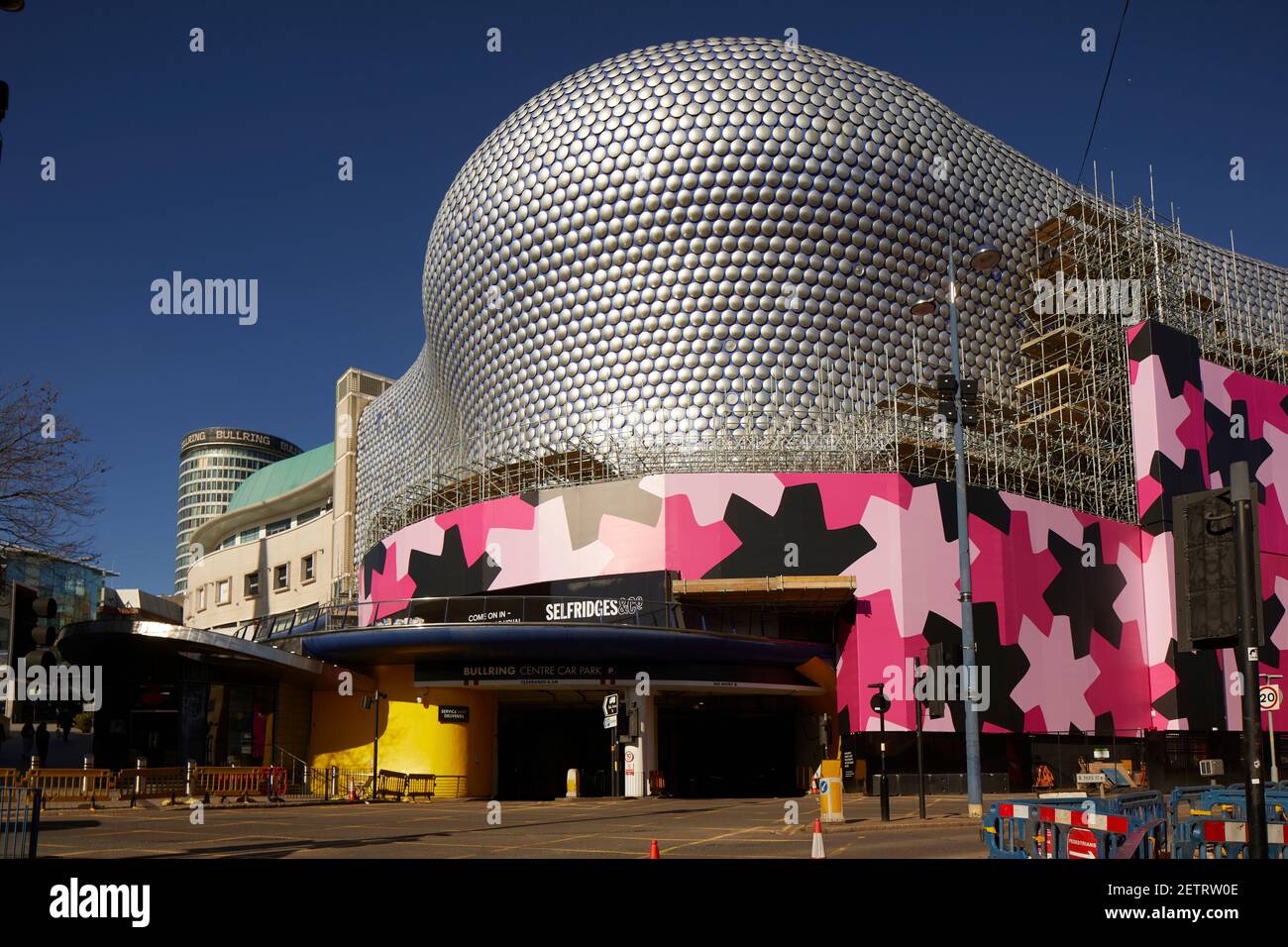 Birmingham city centre landmark  iconic Selfridges building enveloped bold eye-catching pink black wrap while the original design is cleaned repainted Stock Photo