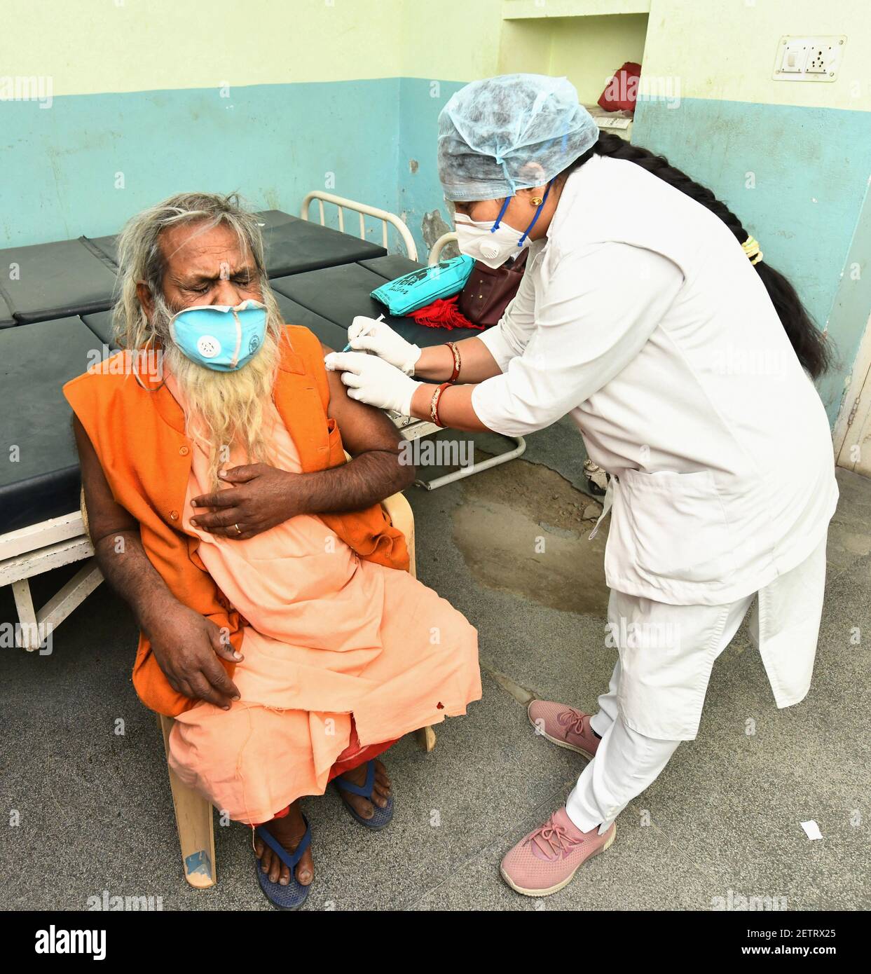Beawar, Rajasthan, India, March 2, 2021: An elderly monk being administered COVID-19 vaccine, during a countrywide inoculation drive, at Government hospital in Beawar. The second phase of the Covid-19 vaccination drive started for people 60 years of age and above. 70 years old Indian Prime Minister Narendra Modi also received his first dose of Corona vaccine at AIIMS in New Delhi on Monday. Credit: Sumit Saraswat/Alamy Live News Stock Photo