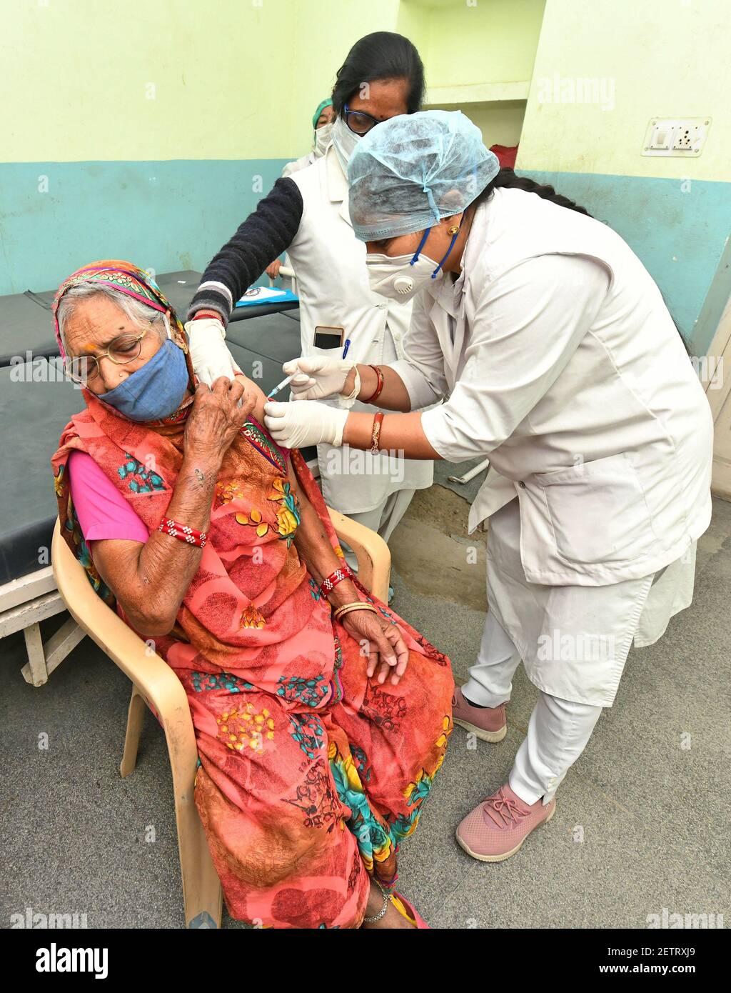 Beawar, Rajasthan, India, March 2, 2021: An elderly woman being administered COVID-19 vaccine, during a countrywide inoculation drive, at Government hospital in Beawar. The second phase of the Covid-19 vaccination drive started for people 60 years of age and above. 70 years old Indian Prime Minister Narendra Modi also received his first dose of Corona vaccine at AIIMS in New Delhi on Monday. Credit: Sumit Saraswat/Alamy Live News Stock Photo