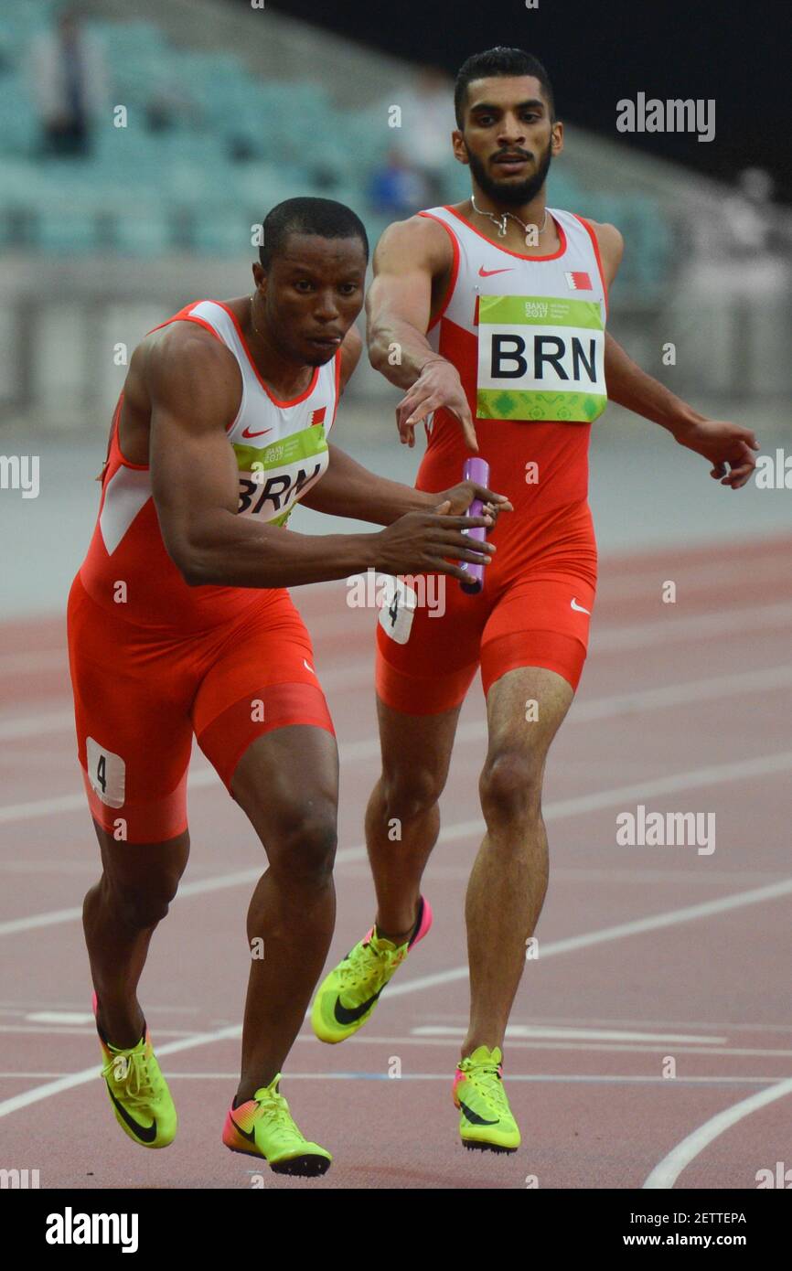 Salem Eid Yaqoob of Bahrain passes the relay baton to Musa Isah in Men ...