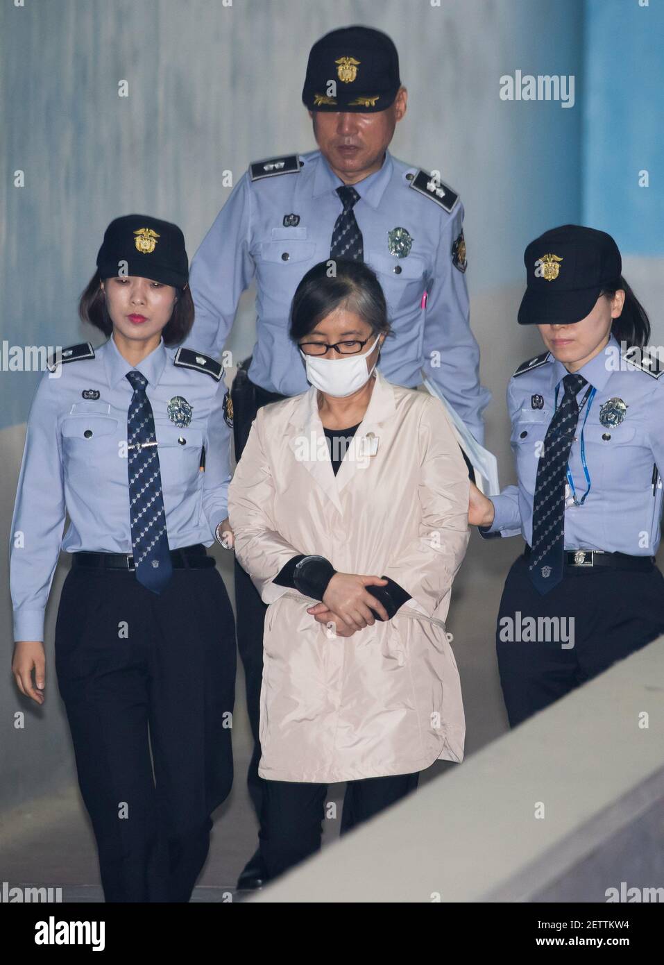 23 May 2017 - Seoul, South Korea : South Korean Choi Soon-sil, a long-time friend of former South Korea's President Park Geun-hye, (center), is escorted by prison officers as she arrives at the Seoul Central District Court in Seoul, South Korea, on May 23, 2017. Photographer: SeongJoon Cho/Pool *** Please Use Credit from Credit Field *** Stock Photo