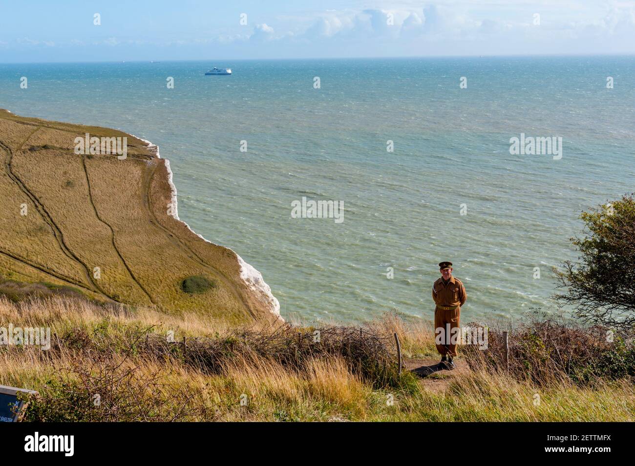 WW2 soldier Actor standing on the cliffs Looking towards France from the top of The white cliffs of Dover at Langdon Bay Stock Photo
