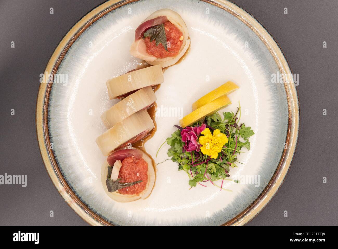 Overhead view of rings of albacore fish filled with spicy tuna sushi with  beautiful presentation on a plate garnished topped with a flower Stock  Photo - Alamy, image size:1300x957