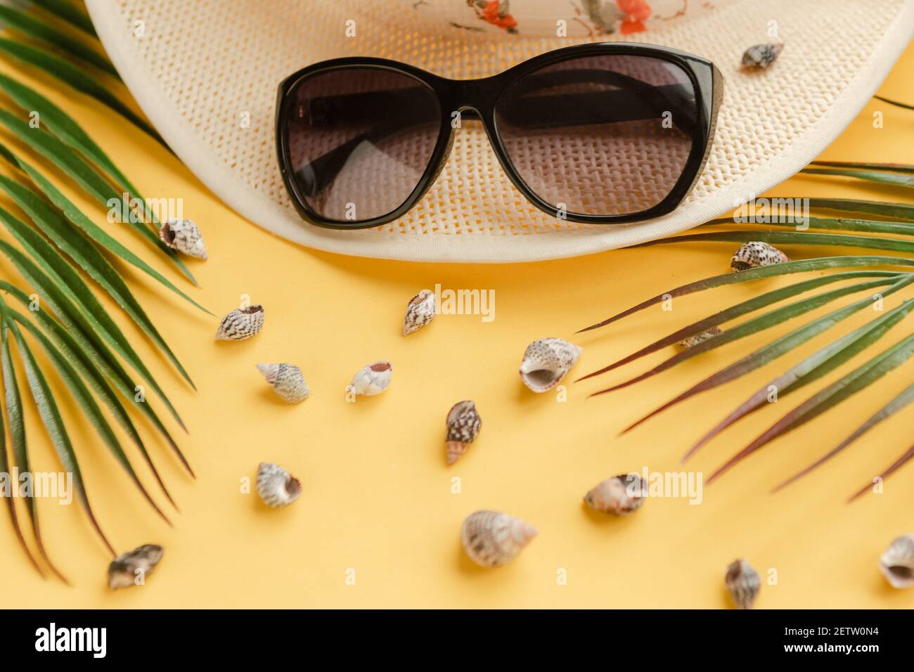 Straw hat with sunglasses on bright yellow background. Summer vacation ...