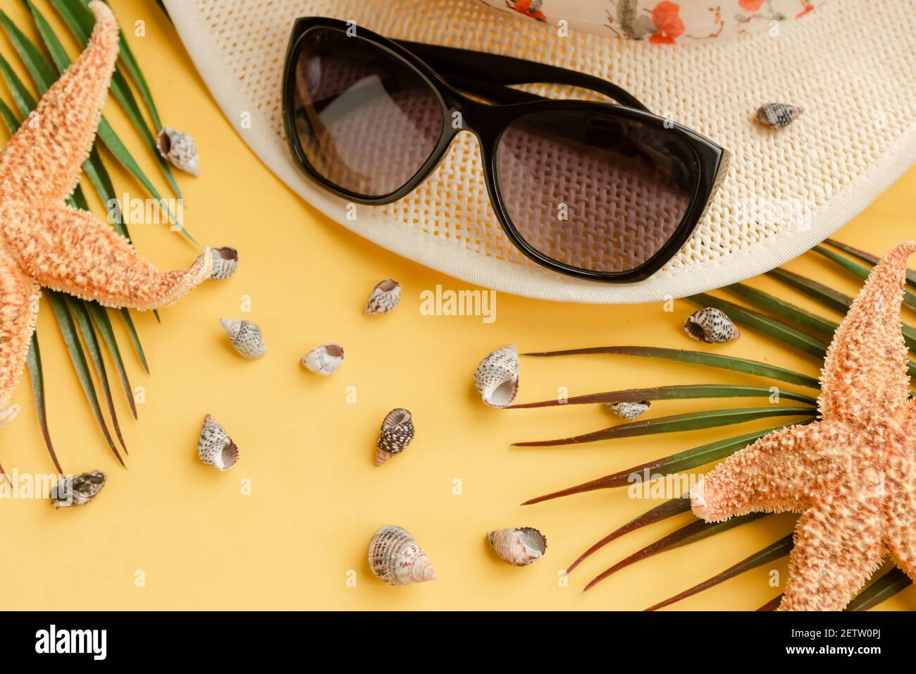 Straw hat with sunglasses on bright yellow background. Summer vacation ...