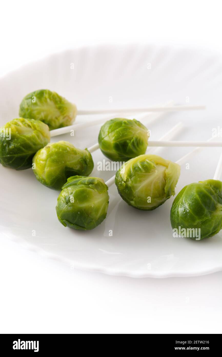 Set of brussel sprouts with lollipop sticks on white background Stock Photo