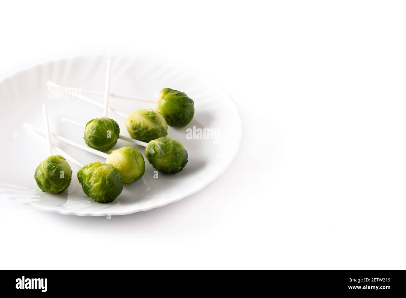 Set of brussel sprouts with lollipop sticks on white background Stock