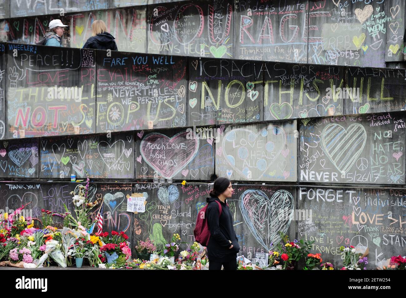 People visit a memorial in Portland, Ore., on May 30, 2017, after 23 ...