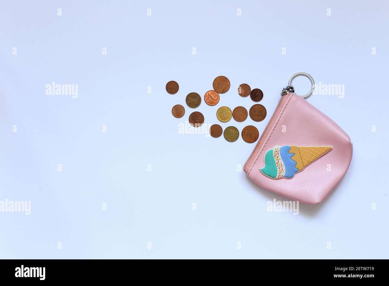 A children's wallet with kopecks is on the table. Money lies near the piggy bank on the background. High quality photo Stock Photo