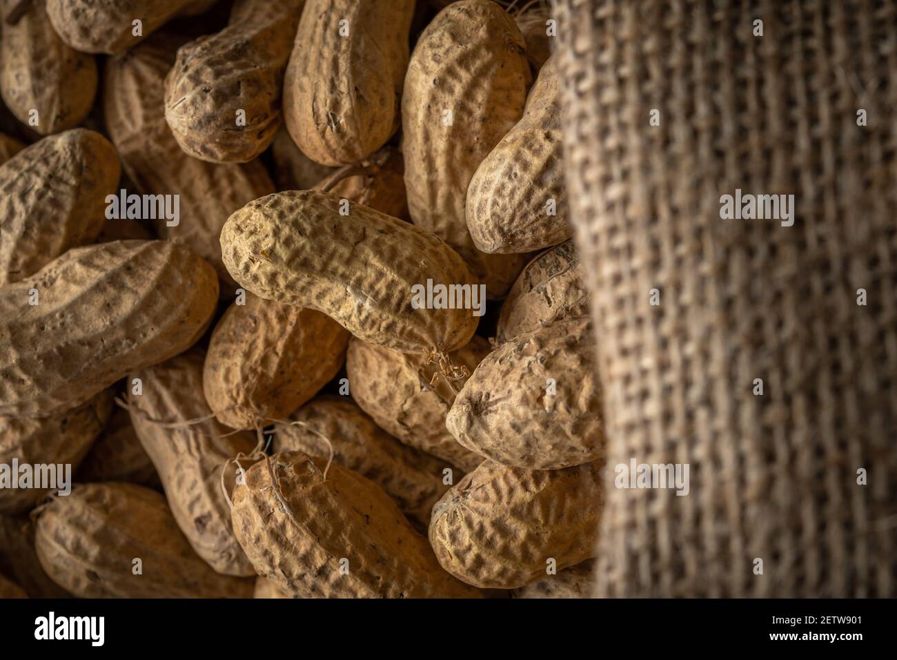 Close-up view of peanut in sack bag. Food background. Stock Photo