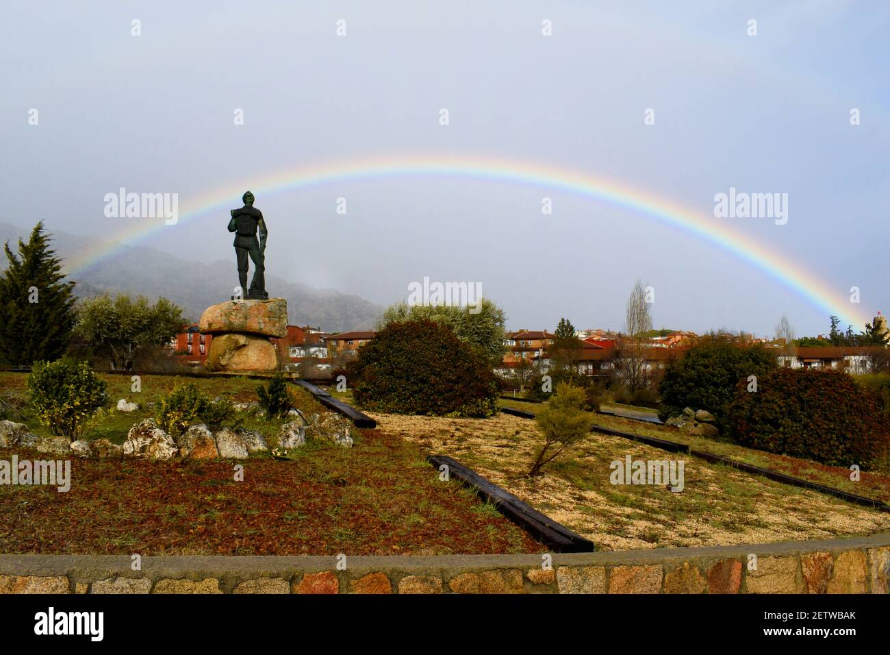Rainbow in the mountain. A complete rainbow in the Sierra de Guadarrama, in the town of Manzanares El Real, Community of Madrid, Spain Stock Photo