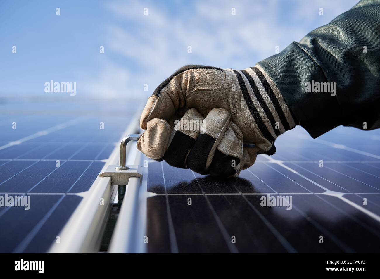 Close up of worker hand in glove holding a hex key, installing ...