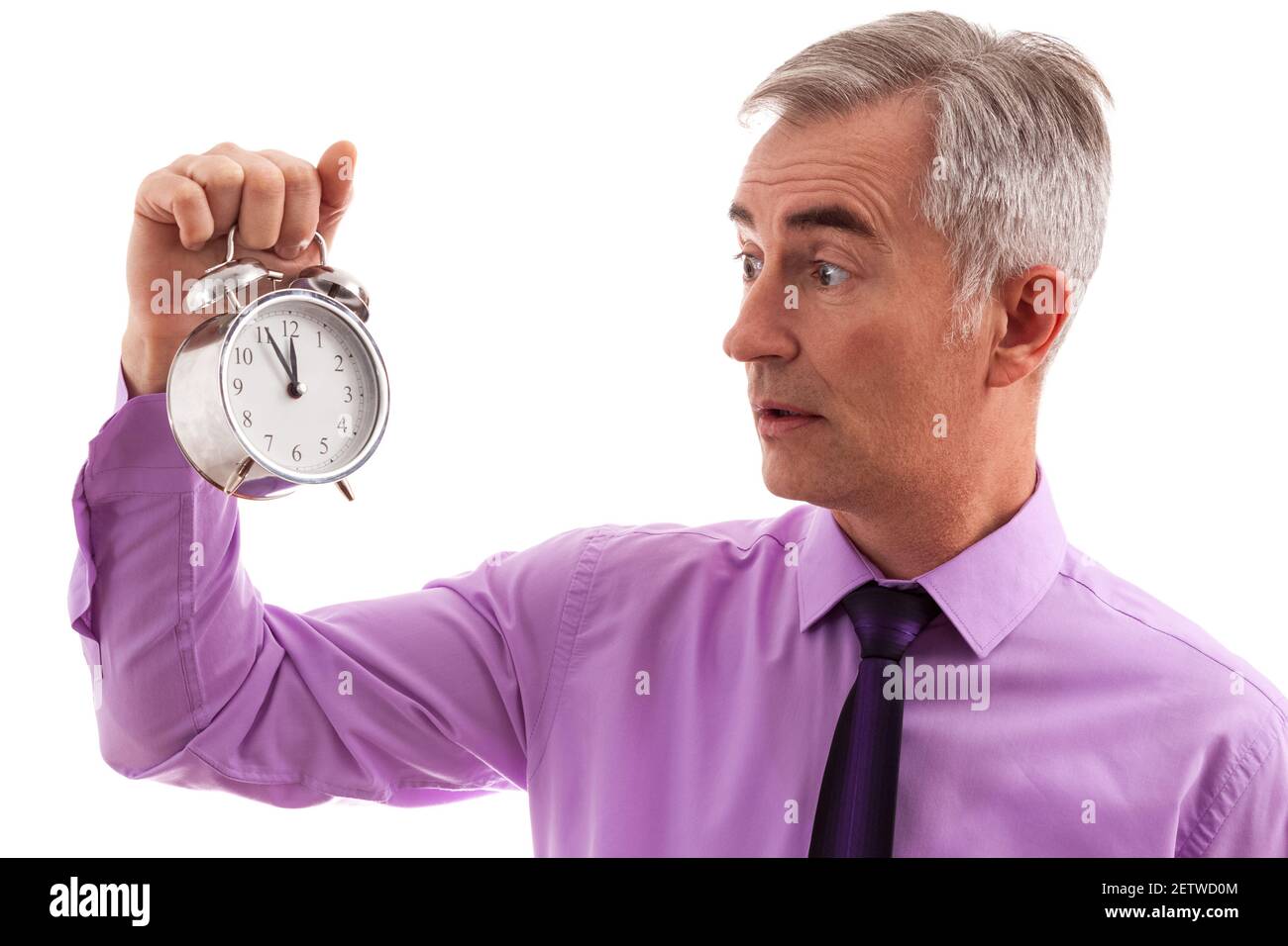 Stressed businessman holding clock in hand Stock Photo