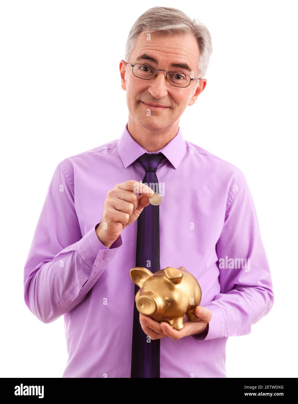 Business man putting coin into piggy bank Stock Photo - Alamy