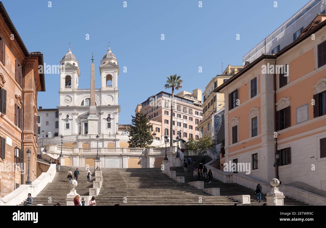 Rome, Italy - February 25 2021: A view of Trinità dei Monti and Spanish Steps during the Coronavirus emergency with few people passing by Stock Photo