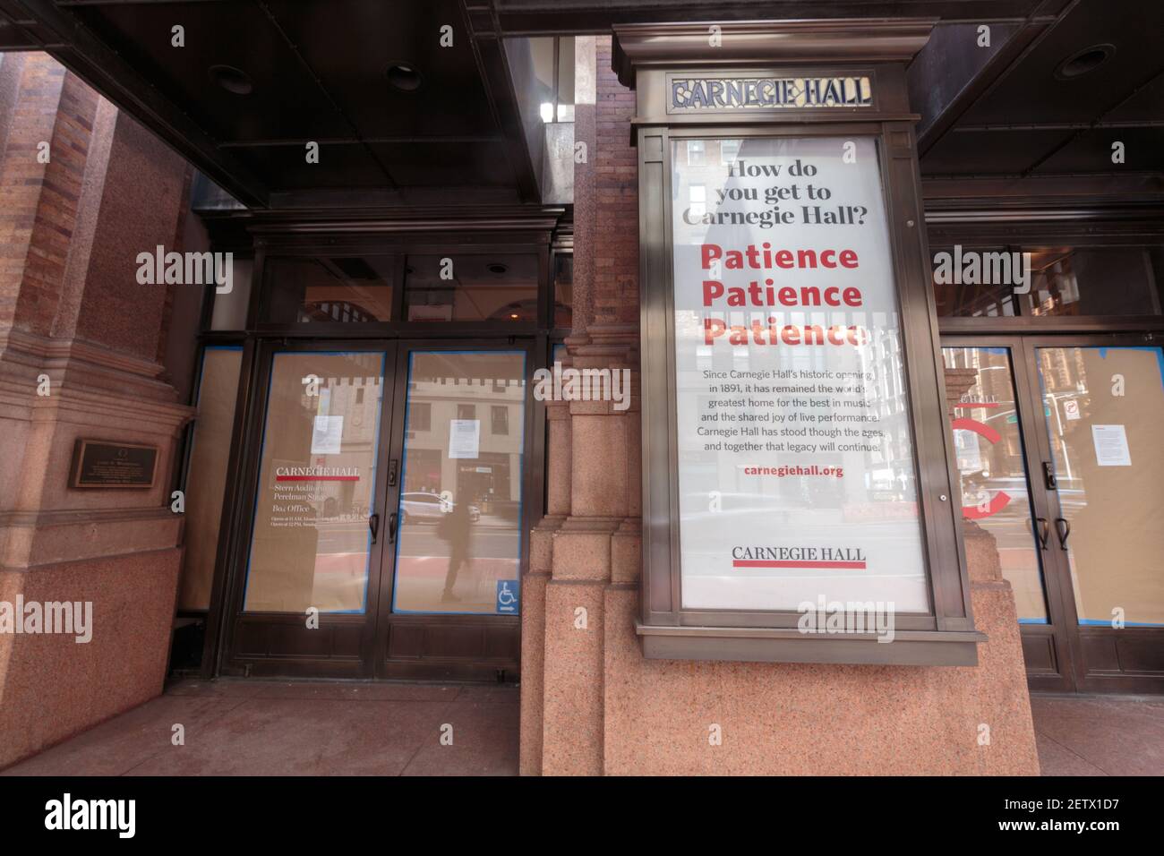the entrance of Carnegie Hall with the glass doors papered over; the Hall has been closed through the coronavirus or covid-19 pandemic Stock Photo