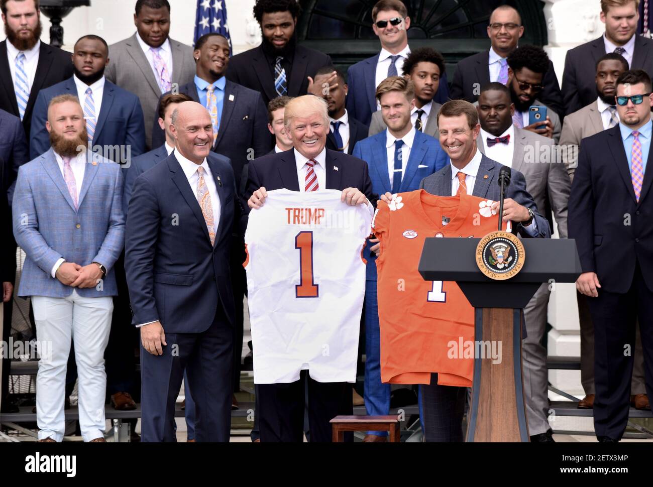 President Donald Trump holds a jersey during a ceremony to welcome the 2016  NCAA Football National Champions The Clemson Tigers on the South Lawn of  the White House on June 12, 2017.