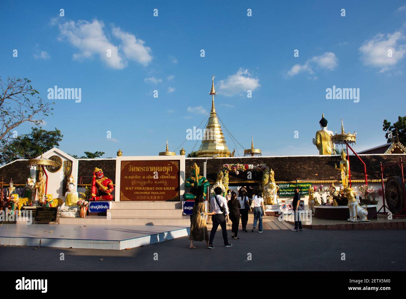 Thai people and foreign travelers travel visit respect praying buddha god angel deity of Wat Phra That Doi Kham or Temple of the Golden Mountain at Ma Stock Photo
