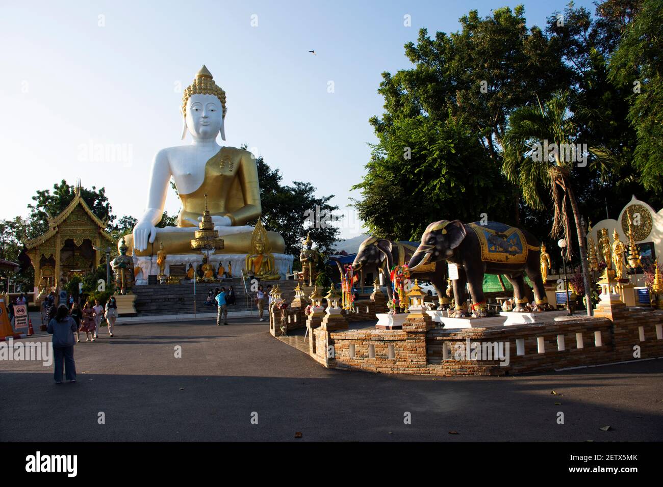 Thai people and foreign travelers travel visit respect praying buddha god angel deity of Wat Phra That Doi Kham or Temple of the Golden Mountain at Ma Stock Photo