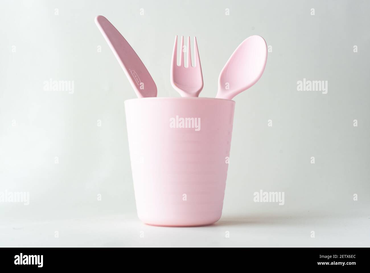 Plastic cup, spoon, fork and a knife isolated on white background Stock Photo