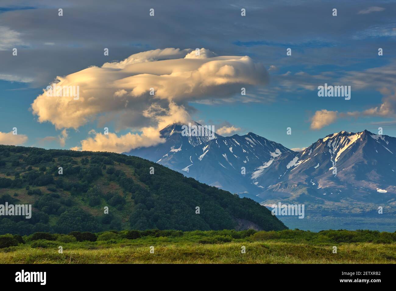 Lenticular cloud formation over volcano Stock Photo