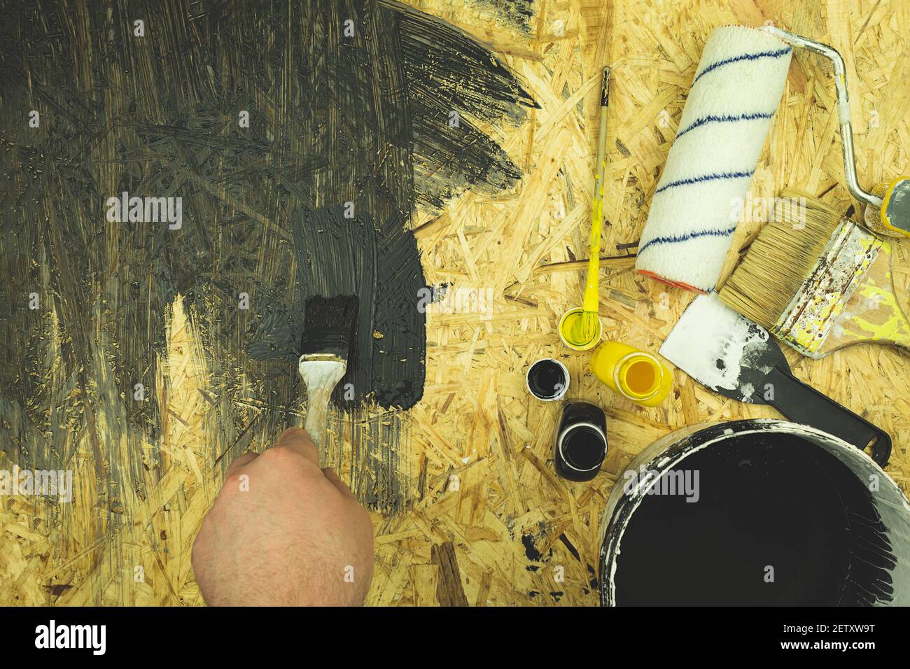 The painter mixes paint and water emulsion. Selection of paint color