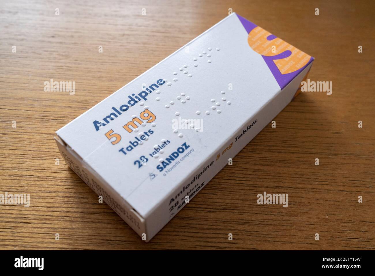 A detailed view of a box of 5mg Amlodipine manufactured by the pharmaceutical Sandoz, a Novartis company, on 1st March 2021, in London, England. Amlodipine is known as a Calcium Blocker used for the reduction of Hypertension (high blood pressure). Stock Photo