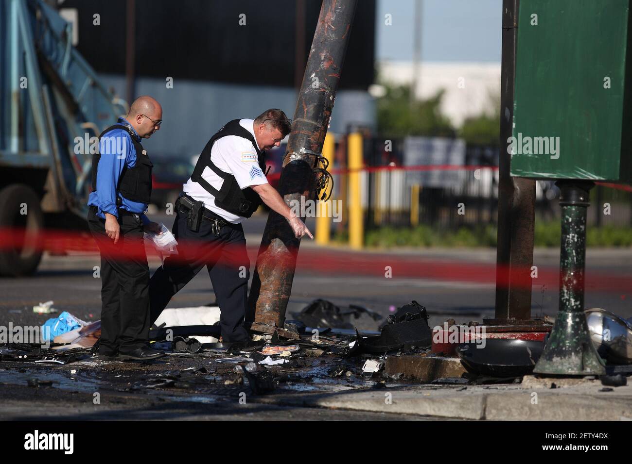 Chicago police officers collect evidence near the scene of a double